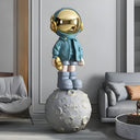 The Voyager life-size blue astronaut sculpture on a moon base