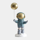 The Dreamer blue astronaut figure with gold balloon