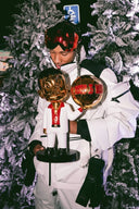 Collector holding a gold and white pop art sculpture